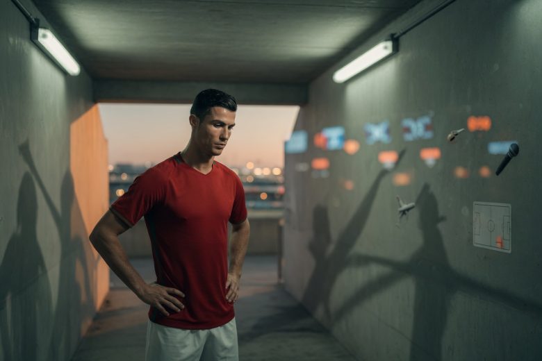 Editorial portrait of Cristiano Ronaldo in a Houston stadium tunnel at dusk, thoughtful, with